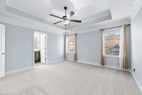 a view of a livingroom with a ceiling fan and window