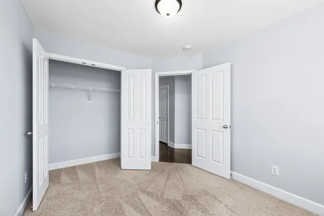 a view of a balcony with chairs and wooden floor