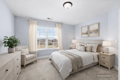 a bedroom with a bed and a couch