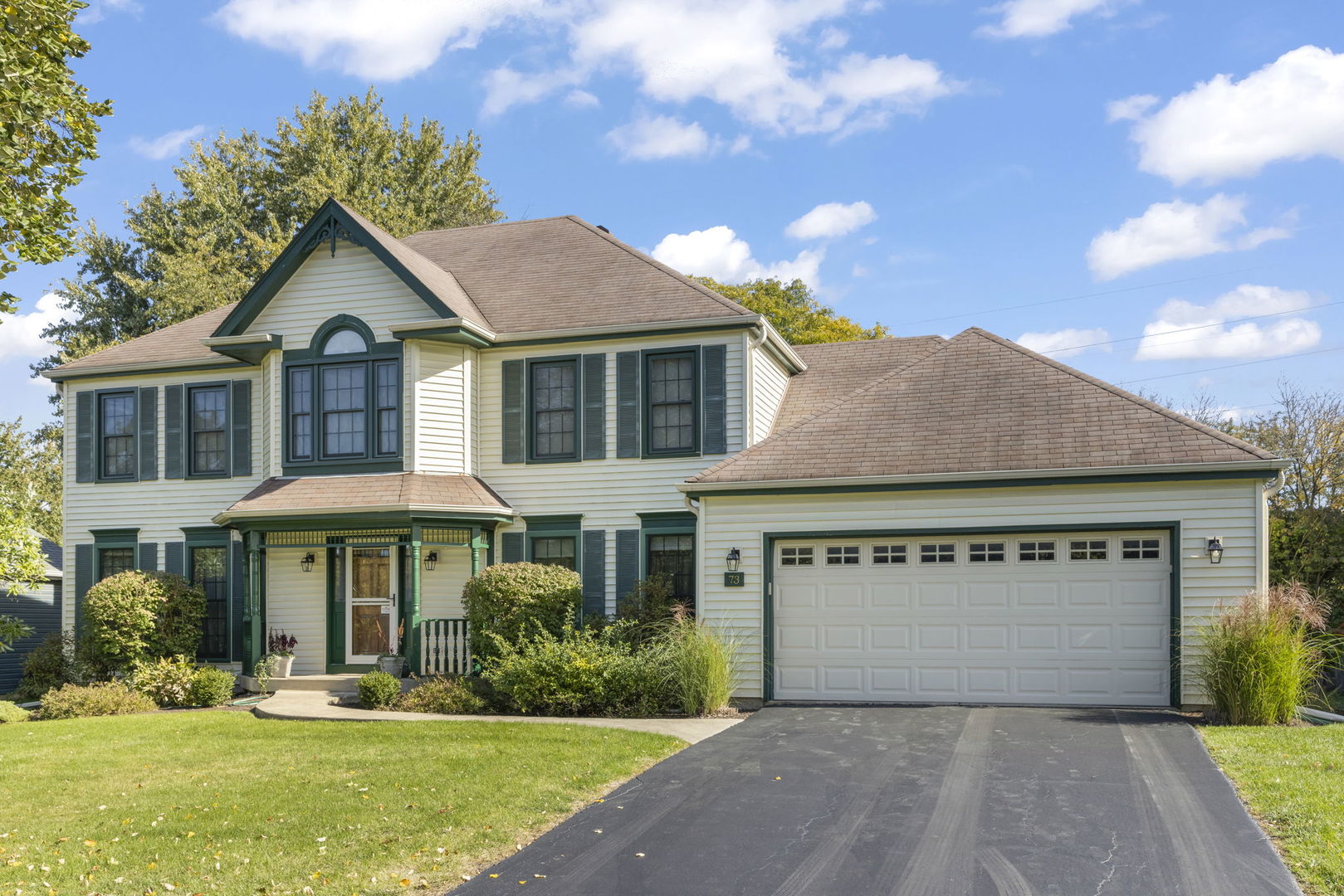 73 Venetian Way Circle Wheaton, IL 60189 - Photo 1 of 47 a front view of a house with a yard and garage