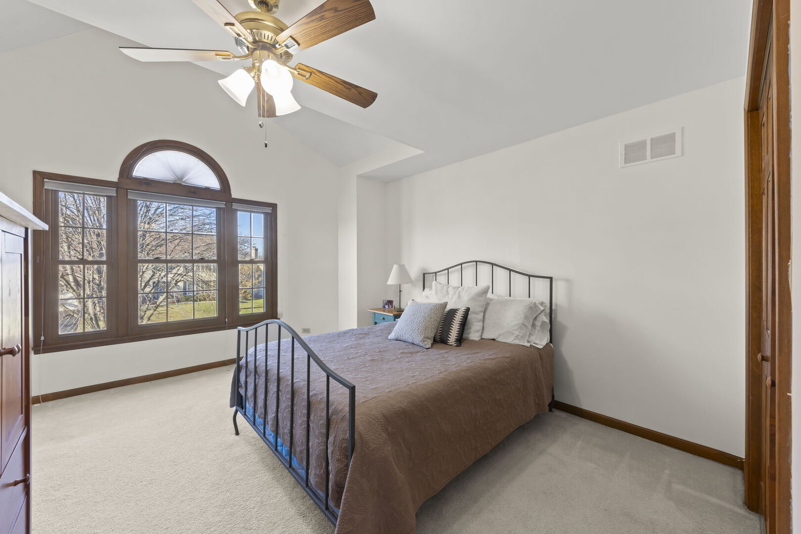 73 Venetian Way Circle Wheaton, IL 60189 - Photo 21 of 47 a bedroom with a large bed and a chandelier