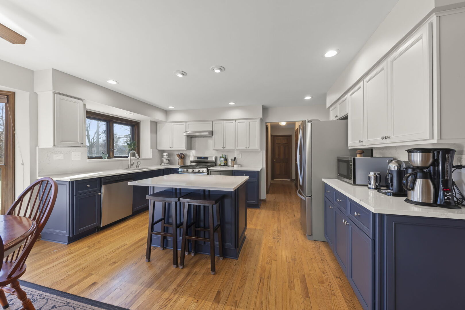 73 Venetian Way Circle Wheaton, IL 60189 - Photo 3 of 47 a kitchen with stainless steel appliances granite countertop a table chairs sink refrigerator and cabinets