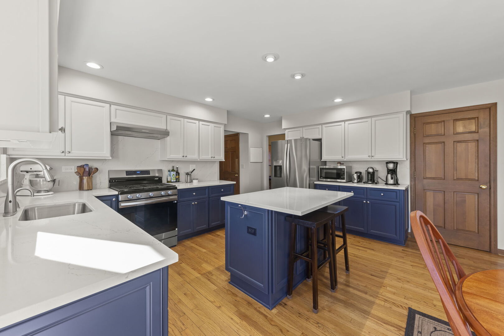 73 Venetian Way Circle Wheaton, IL 60189 - Photo 4 of 47 a kitchen with stainless steel appliances granite countertop a refrigerator a sink dishwasher a stove and white countertops with wooden floor