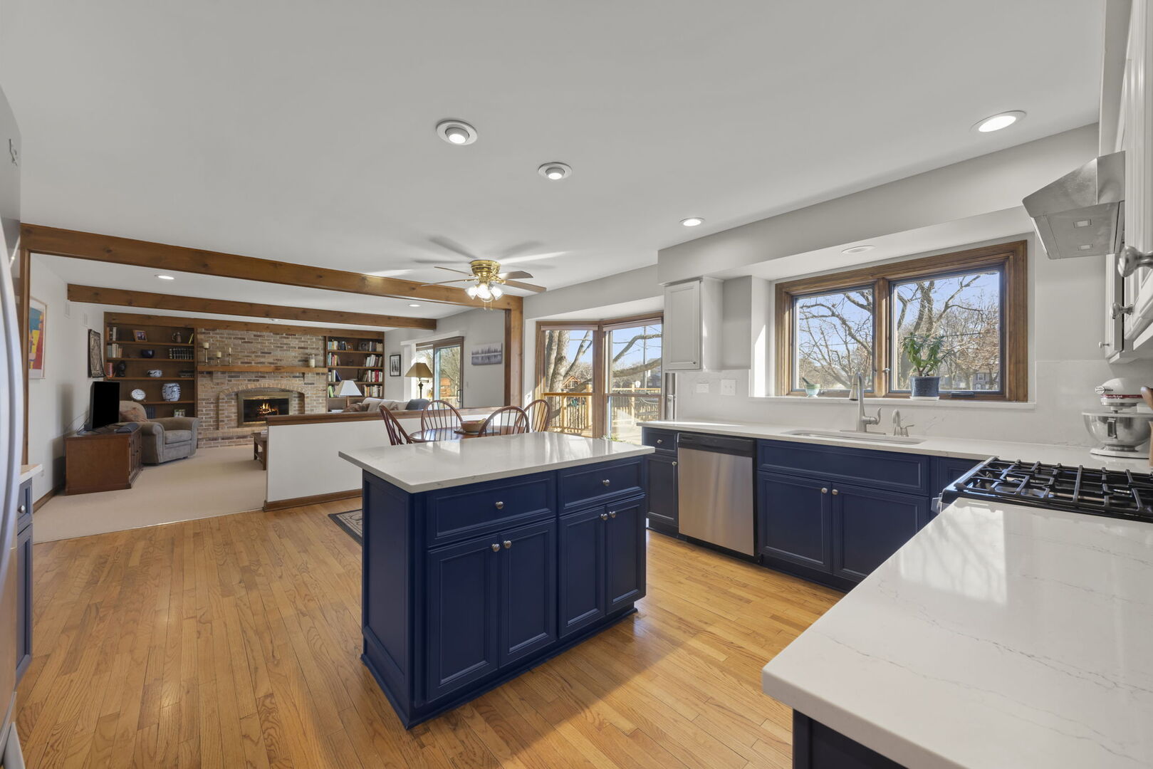 73 Venetian Way Circle Wheaton, IL 60189 - Photo 5 of 47 a kitchen with stainless steel appliances granite countertop a sink dishwasher stove and wooden cabinets with wooden floor