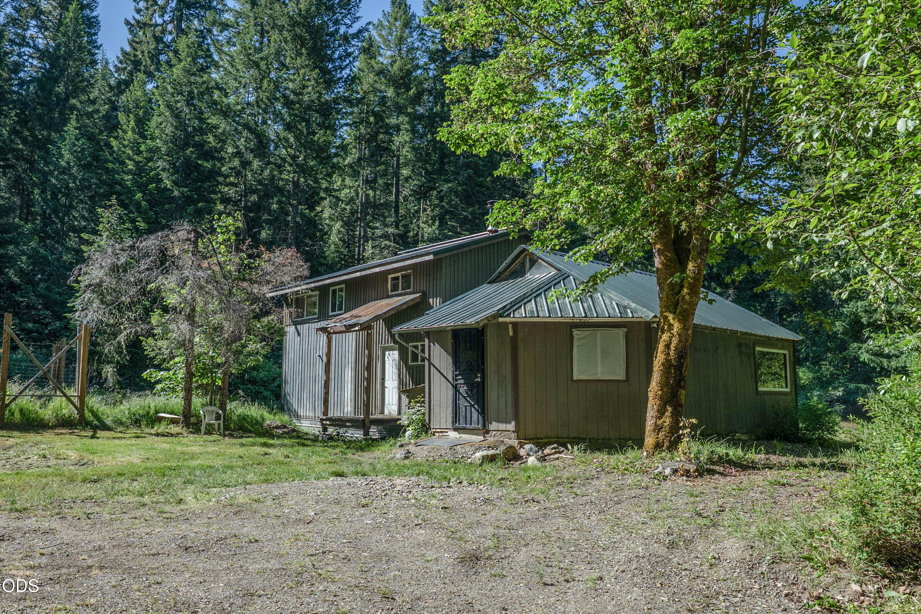 8245 Jumpoff Joe Creek Road Grants Pass, OR 97526 - Photo 2 of 43 a front view of a house with a garden