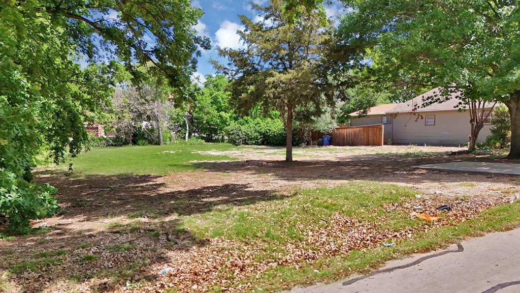 6868 Pecan Street Frisco, TX 75034 - Photo 3 of 8 Cleared lot featuring a combination of grass and natural ground cover