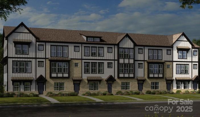 553 Annie Lowery Way Davidson, NC 28036 - Photo 2 of 27 a front view of a residential apartment building with a yard