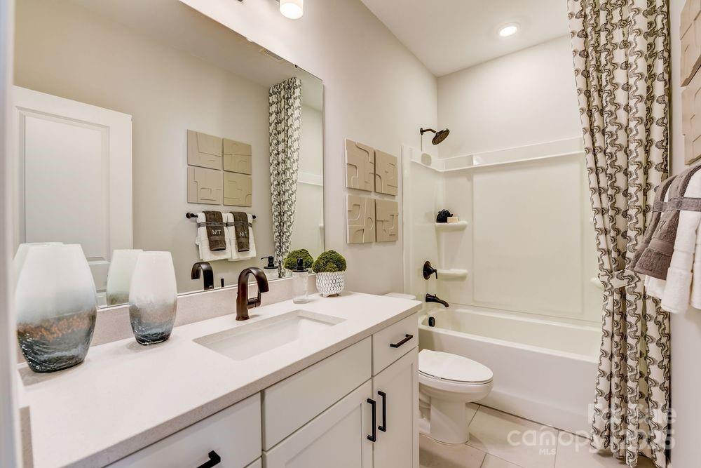 553 Annie Lowery Way Davidson, NC 28036 - Photo 22 of 27 a bathroom with a double vanity sink toilet and shower