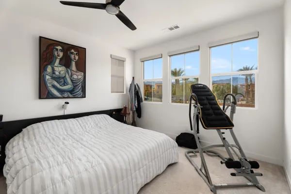 a bedroom with a bed a desk and chair
