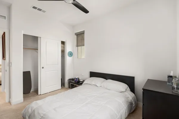 a bed room with furniture and a painting on the wall