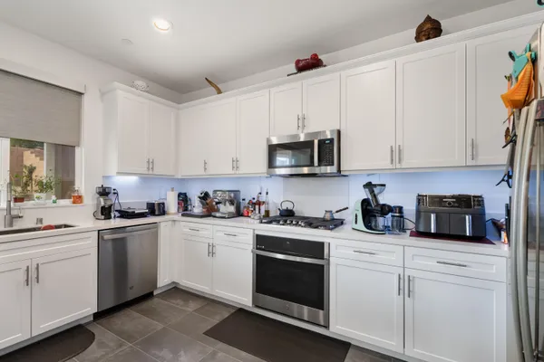 a kitchen with cabinets a sink and appliances