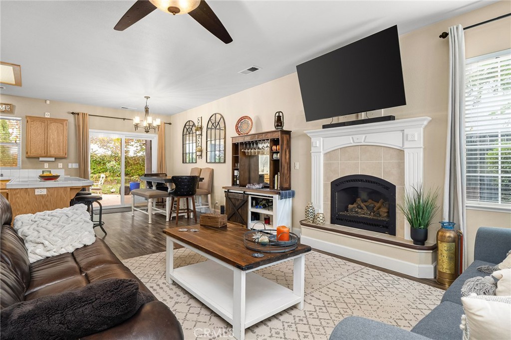 1563 Champlain Way Chico, CA 95973 - Photo 12 of 49 a living room with furniture a flat screen tv and a fireplace