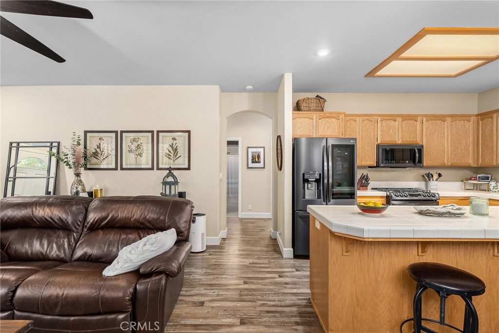 1563 Champlain Way Chico, CA 95973 - Photo 14 of 49 a living room with stainless steel appliances furniture a couch and a kitchen view
