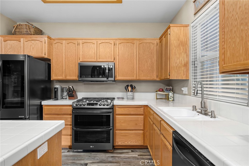 1563 Champlain Way Chico, CA 95973 - Photo 16 of 49 a kitchen with a sink stove and microwave