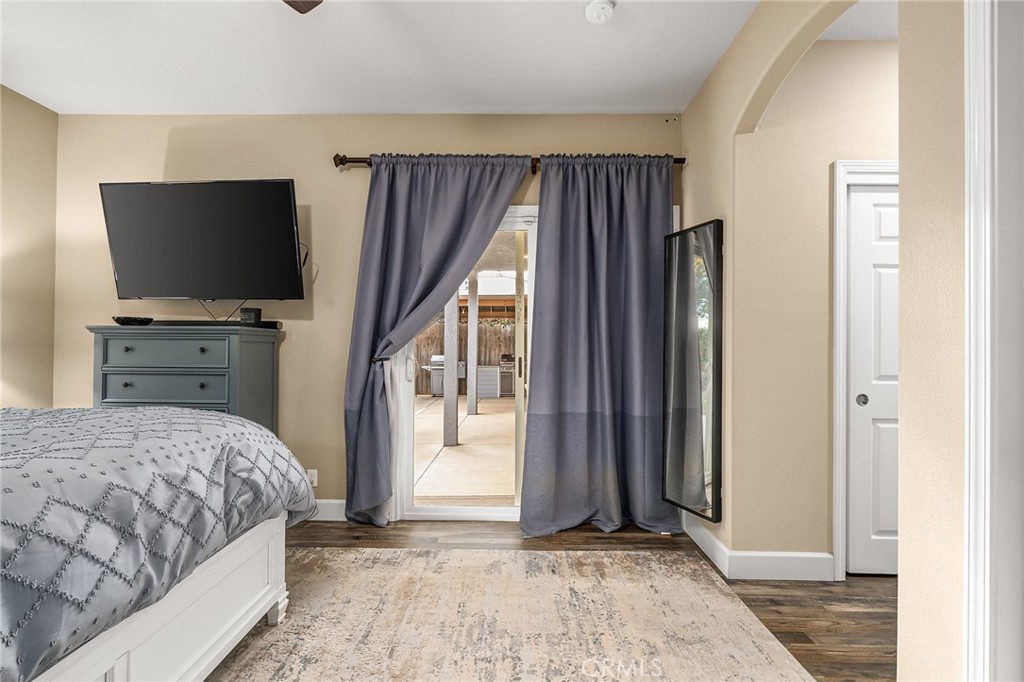 1563 Champlain Way Chico, CA 95973 - Photo 24 of 49 a bedroom with a bed and a flat screen tv