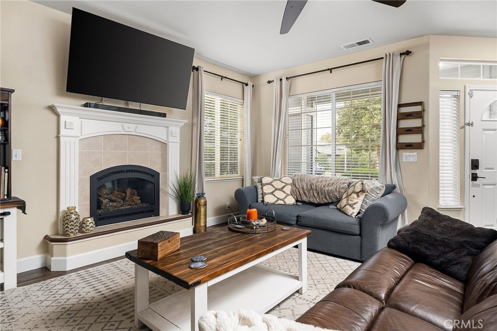 1563 Champlain Way Chico, CA 95973 - Photo 3 of 49 a living room with furniture a flat screen tv and a fireplace