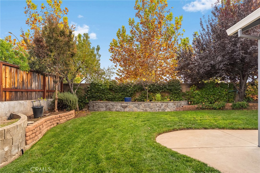 1563 Champlain Way Chico, CA 95973 - Photo 39 of 49 a view of backyard with a garden and trees