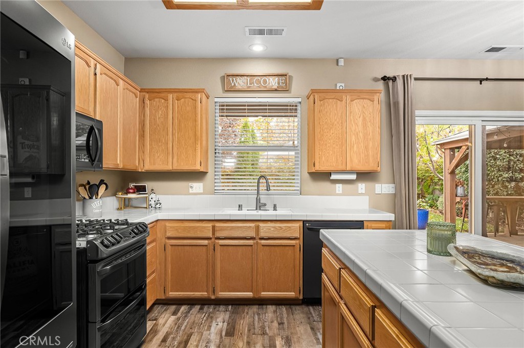 1563 Champlain Way Chico, CA 95973 - Photo 4 of 49 a kitchen with a sink stove and cabinets
