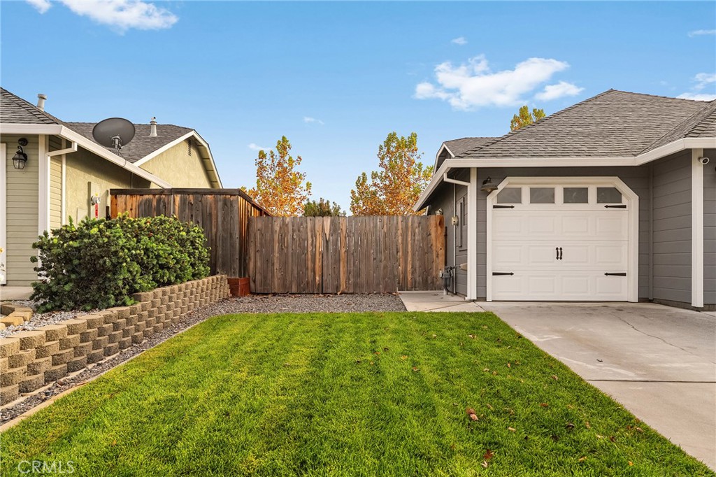 1563 Champlain Way Chico, CA 95973 - Photo 10 of 49 a front view of a house with a yard and garage