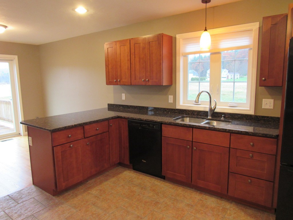 33 Strong Road Southampton, MA 01073 - Photo 6 of 18 a kitchen with stainless steel appliances granite countertop a sink a stove and a wooden cabinets