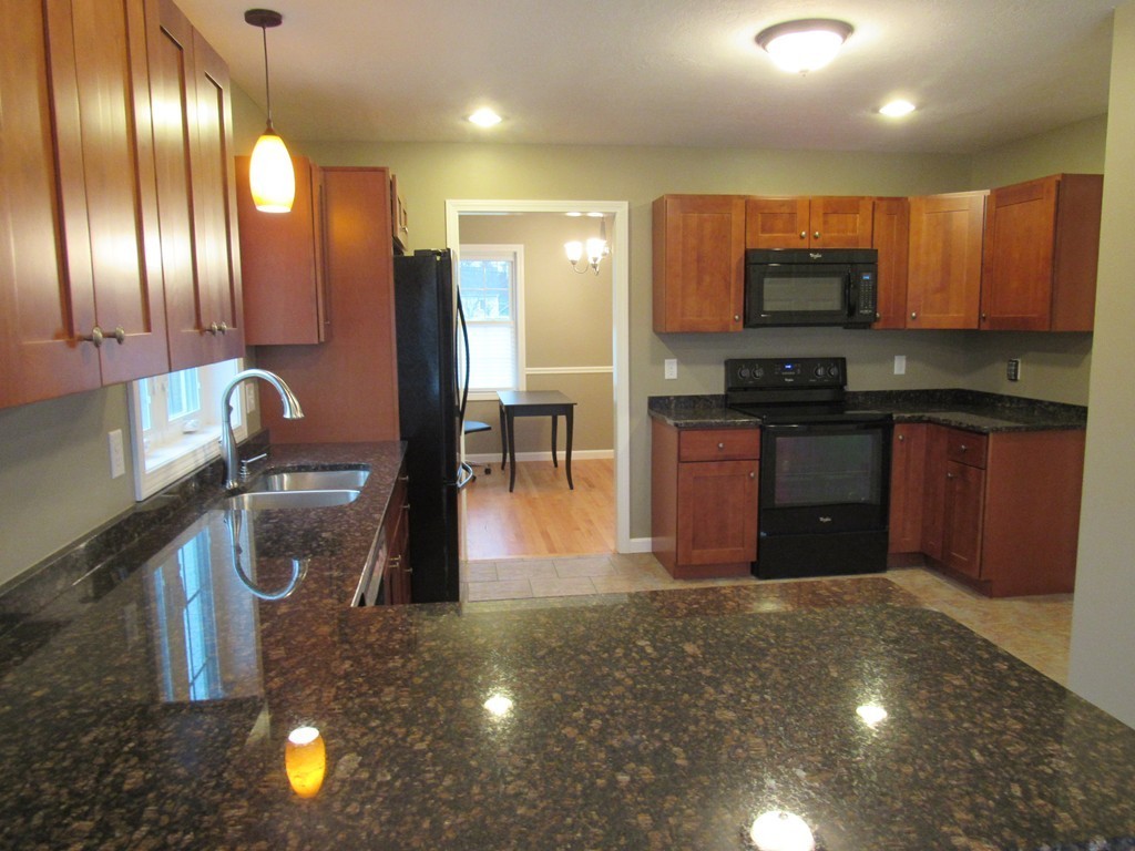 33 Strong Road Southampton, MA 01073 - Photo 7 of 18 a kitchen with stainless steel appliances granite countertop a sink and a stove
