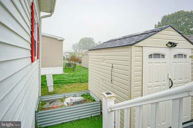 a view of a small house with backyard