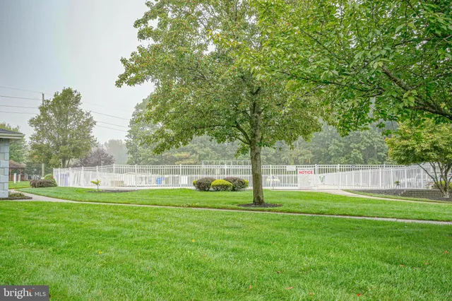 a swimming pool with outdoor seating and yard