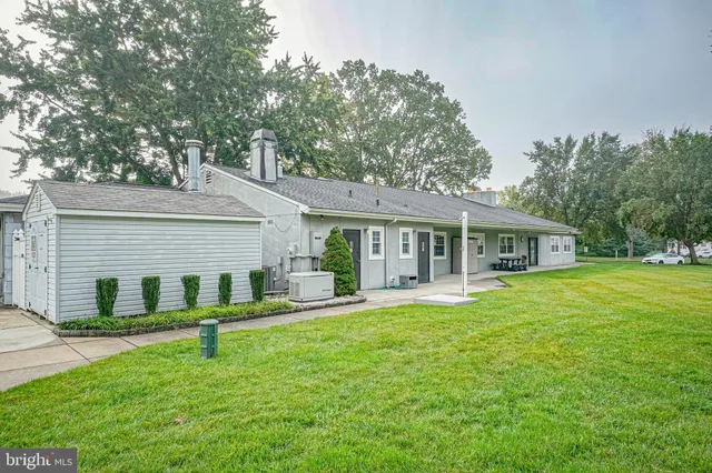a front view of a house with a yard porch and furniture