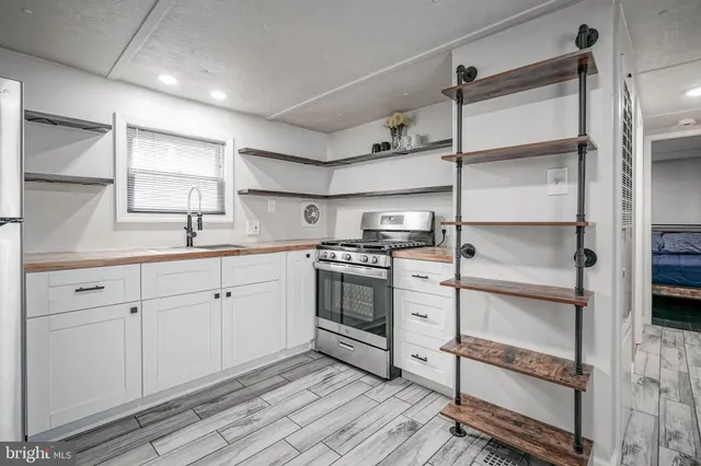 a kitchen with cabinets appliances and a window