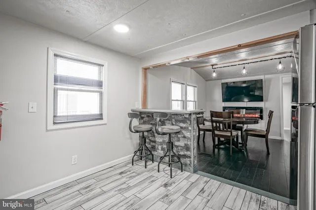 a dining room with furniture and wooden floor