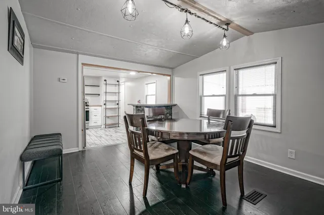 a view of a dining room with furniture and wooden floor