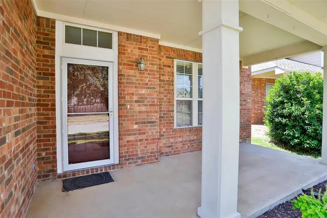 a view of front door of house and tree