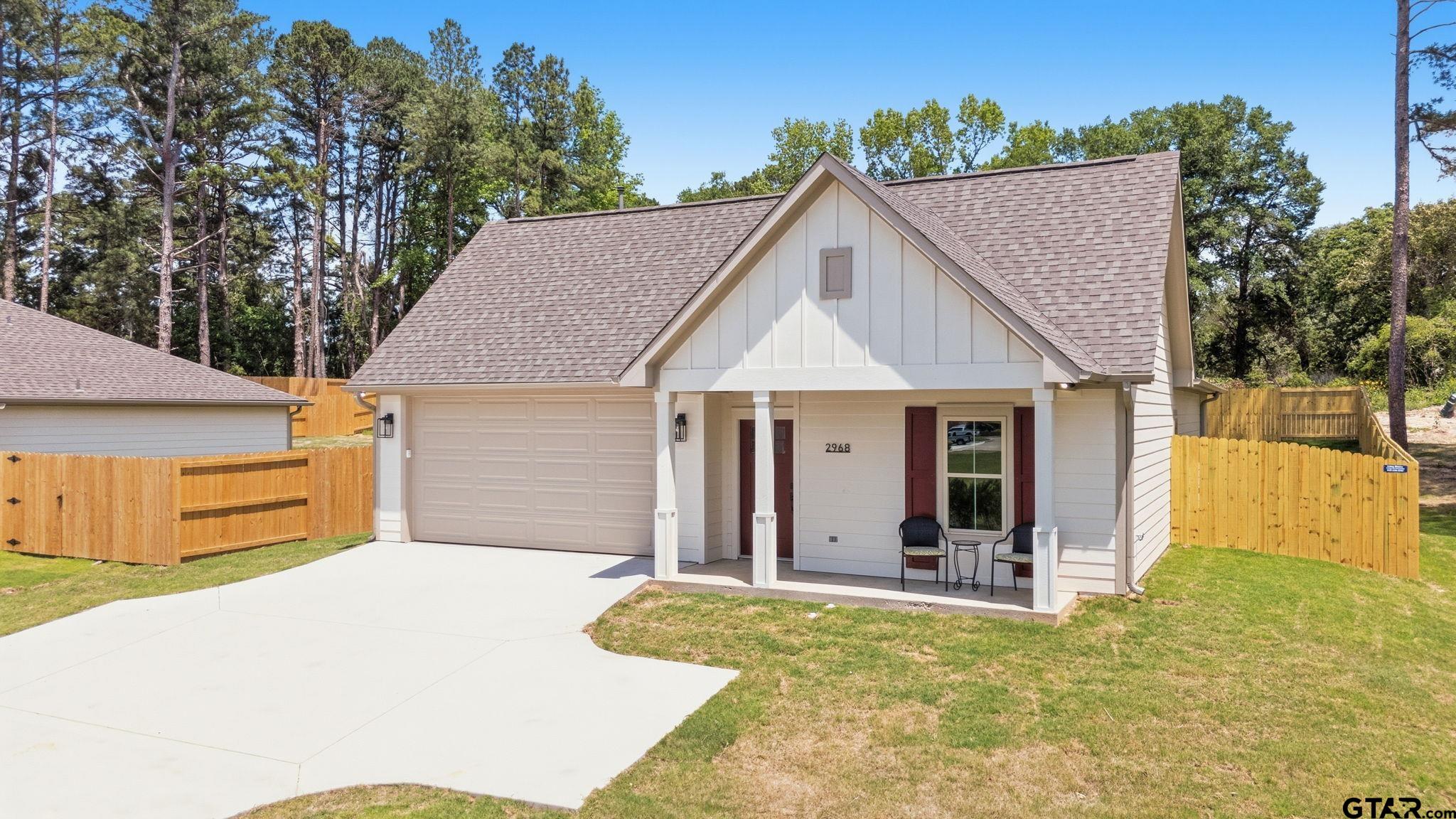 2968 Calloway Road Tyler, TX 75701 - Photo 2 of 24 a view of a white house with large trees and outdoor space