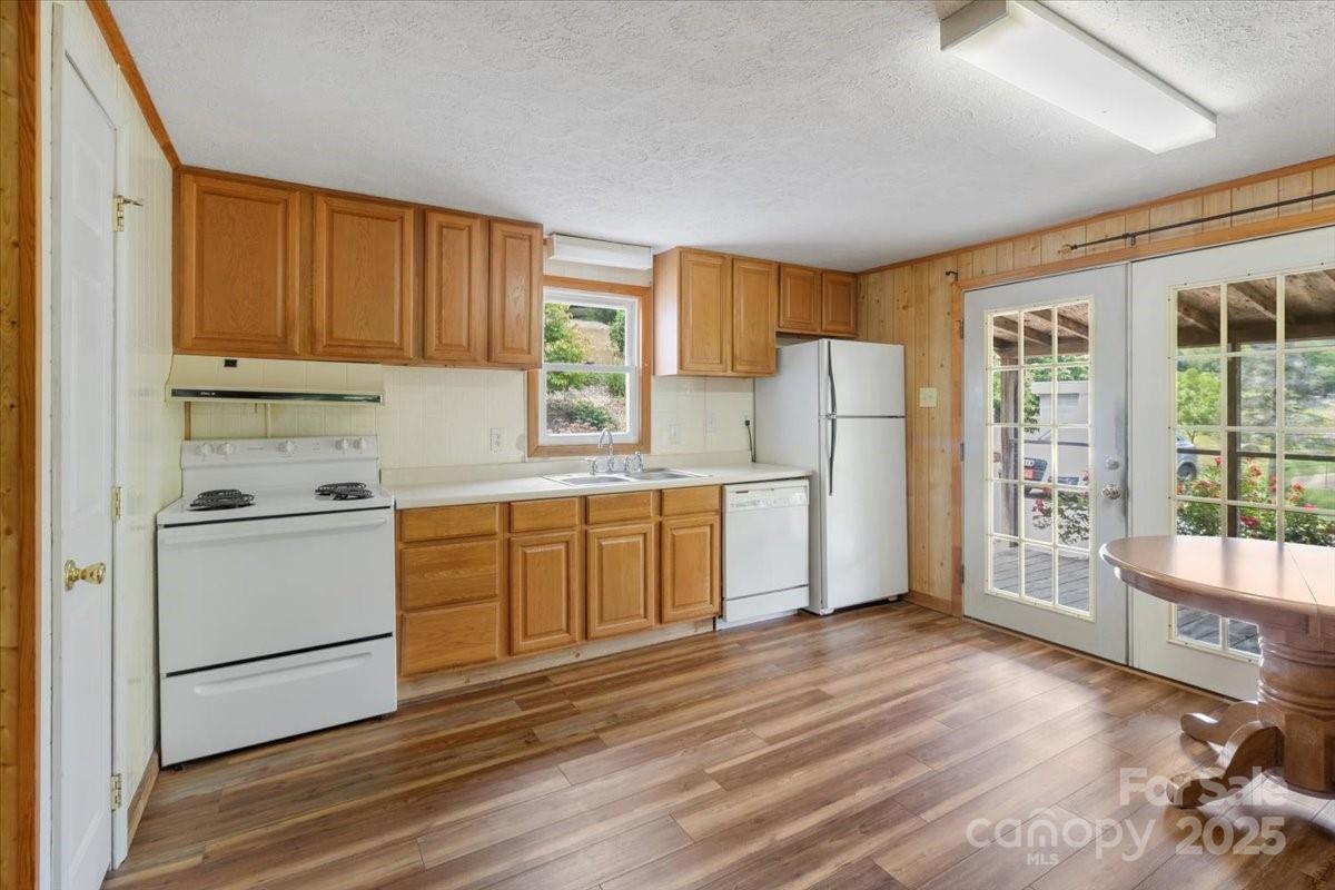 461 Tweed Road Marshall, NC 28753 - Photo 13 of 29 a kitchen with white cabinets and white appliances