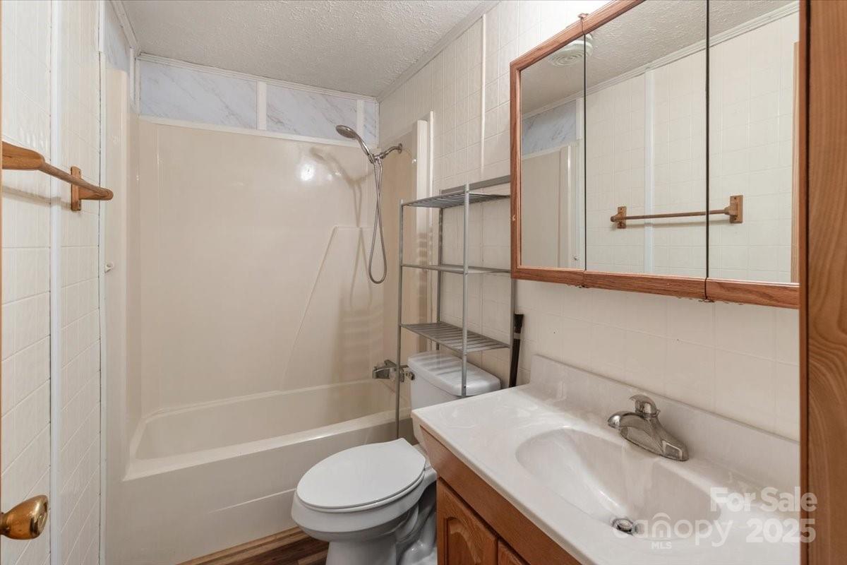 461 Tweed Road Marshall, NC 28753 - Photo 20 of 29 a bathroom with a sink toilet and shower