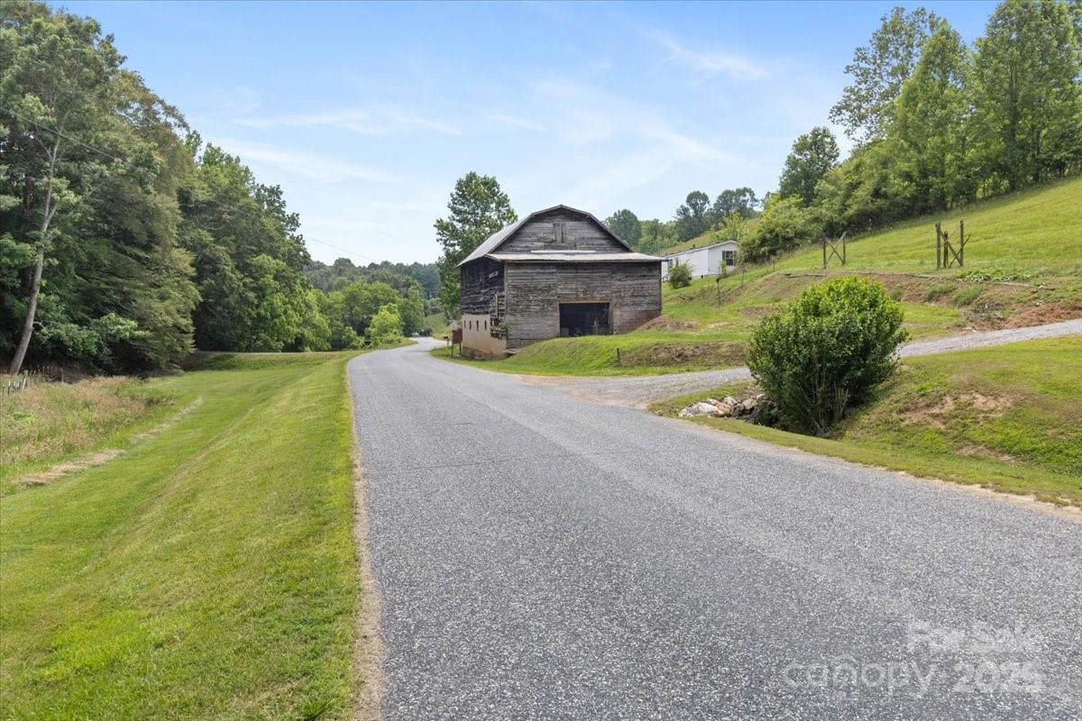 461 Tweed Road Marshall, NC 28753 - Photo 8 of 29 a front view of a house with a yard and garage