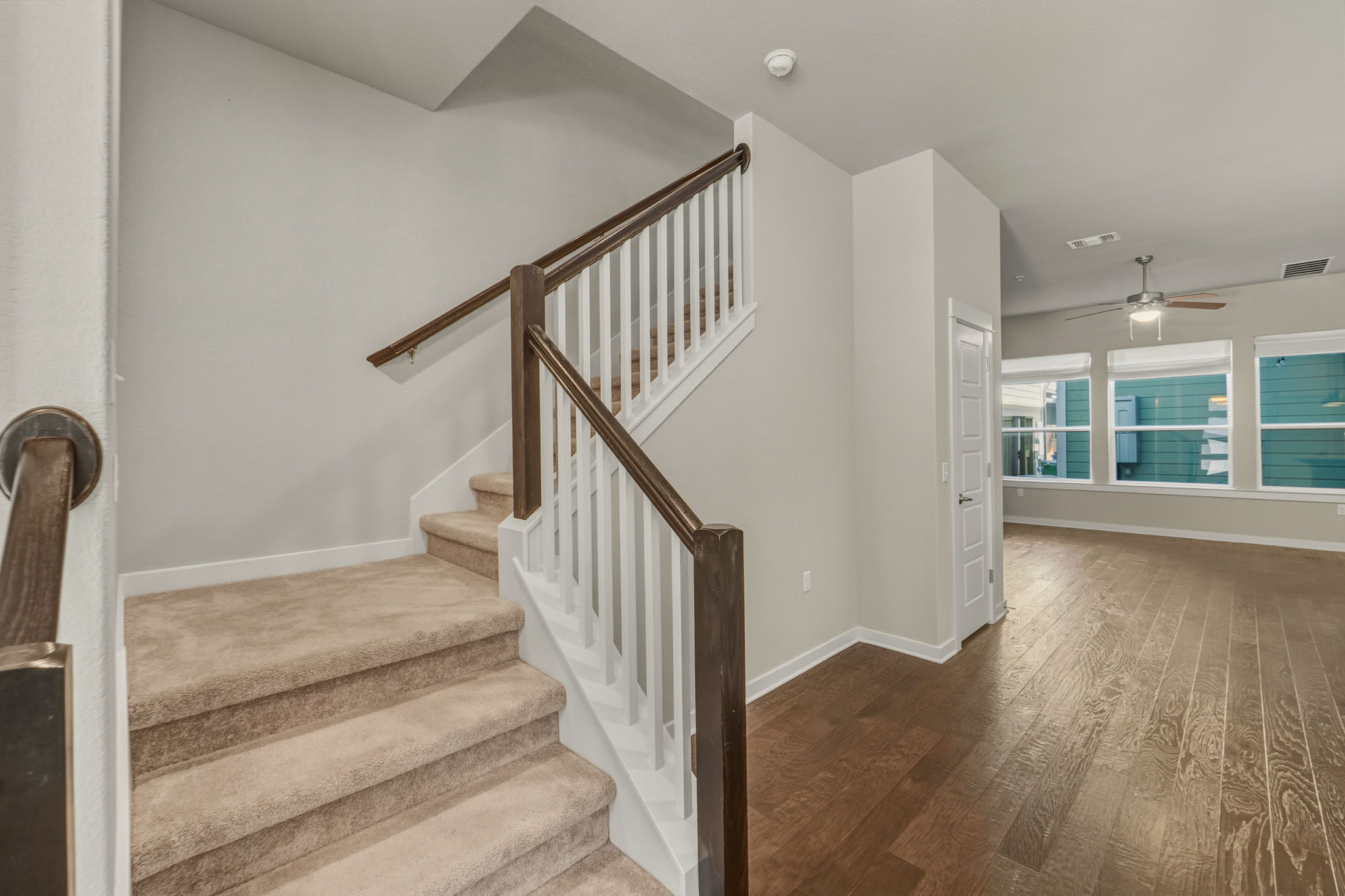 3919 Vaughan Street Austin, TX 78723 - Photo 20 of 40 A grand staircase with rich wood banisters welcomes you into this inviting interior, framed by durable hardwood flooring.
