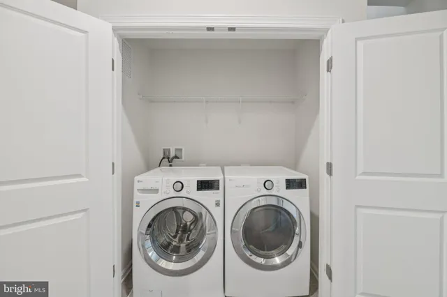 a bedroom with two beds and a large window