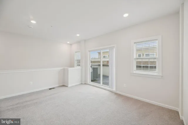 an empty room with a fireplace and a window