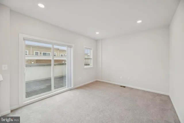 a view of a patio with table and chairs