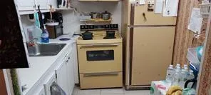 a kitchen with refrigerator and white cabinets