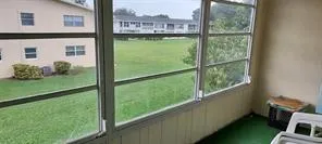 a view of a balcony with lake view and a floor to ceiling window