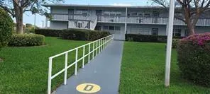 a view of a house with backyard and garden