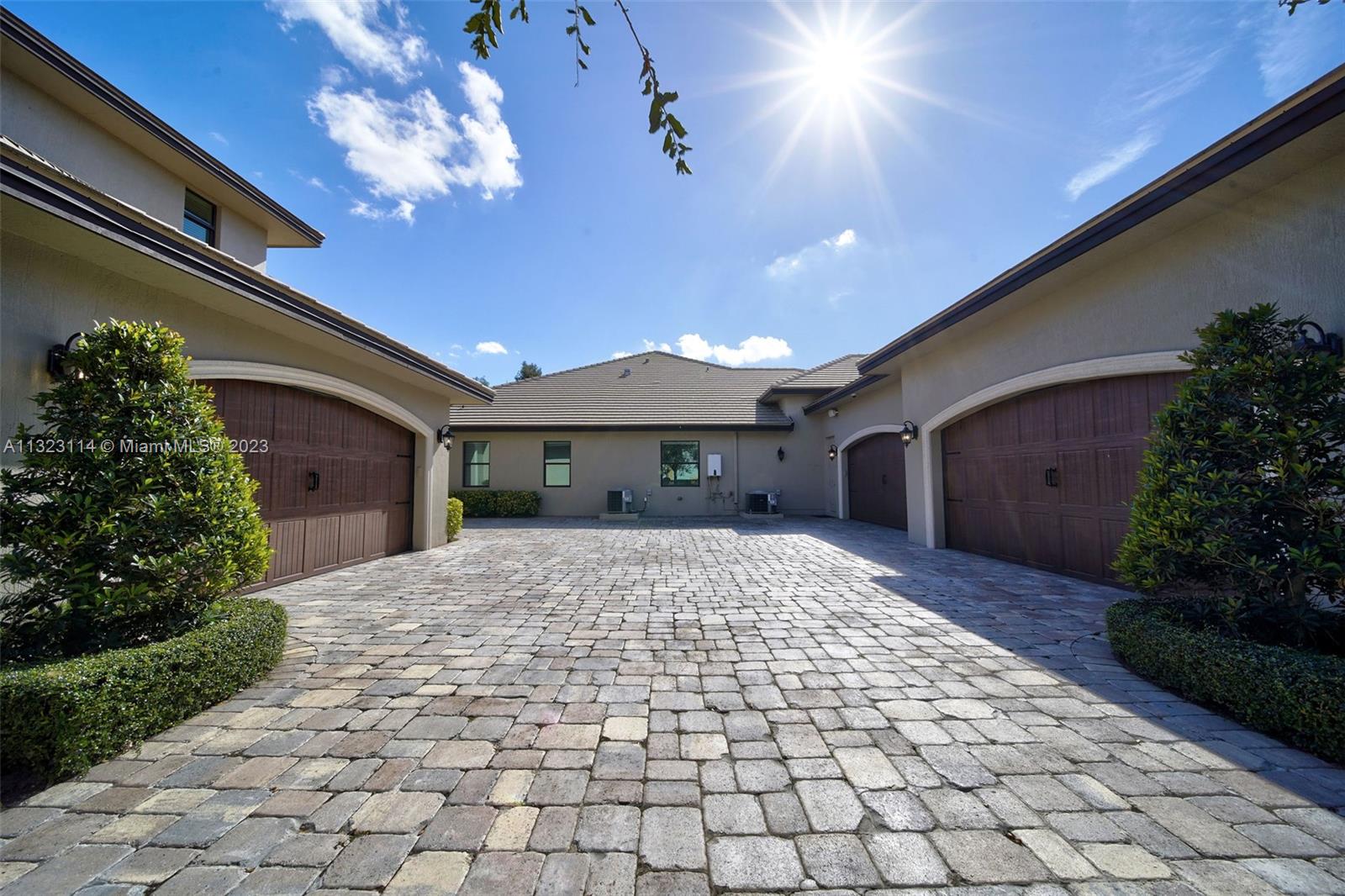 2863 Lake Ridge Lane Weston, FL 33332 - Photo 13 of 60 a view of a porch with a table and chairs and potted plants