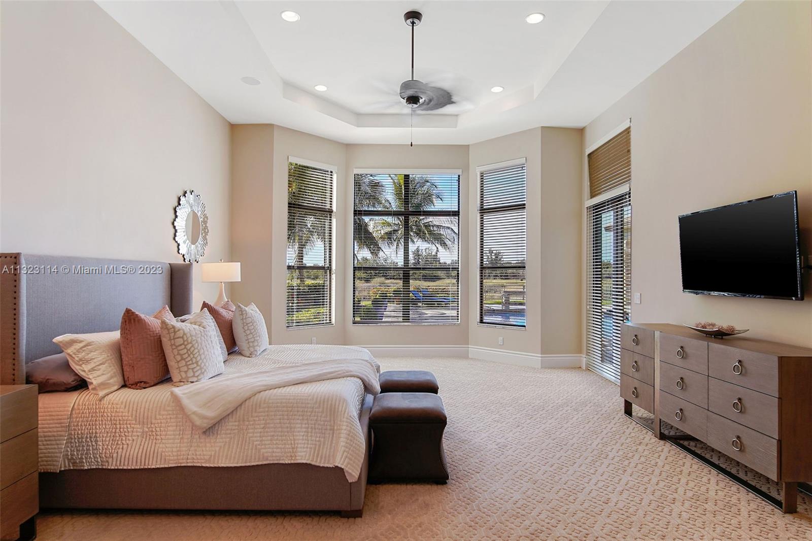 2863 Lake Ridge Lane Weston, FL 33332 - Photo 19 of 60 a bedroom with furniture and a flat screen tv
