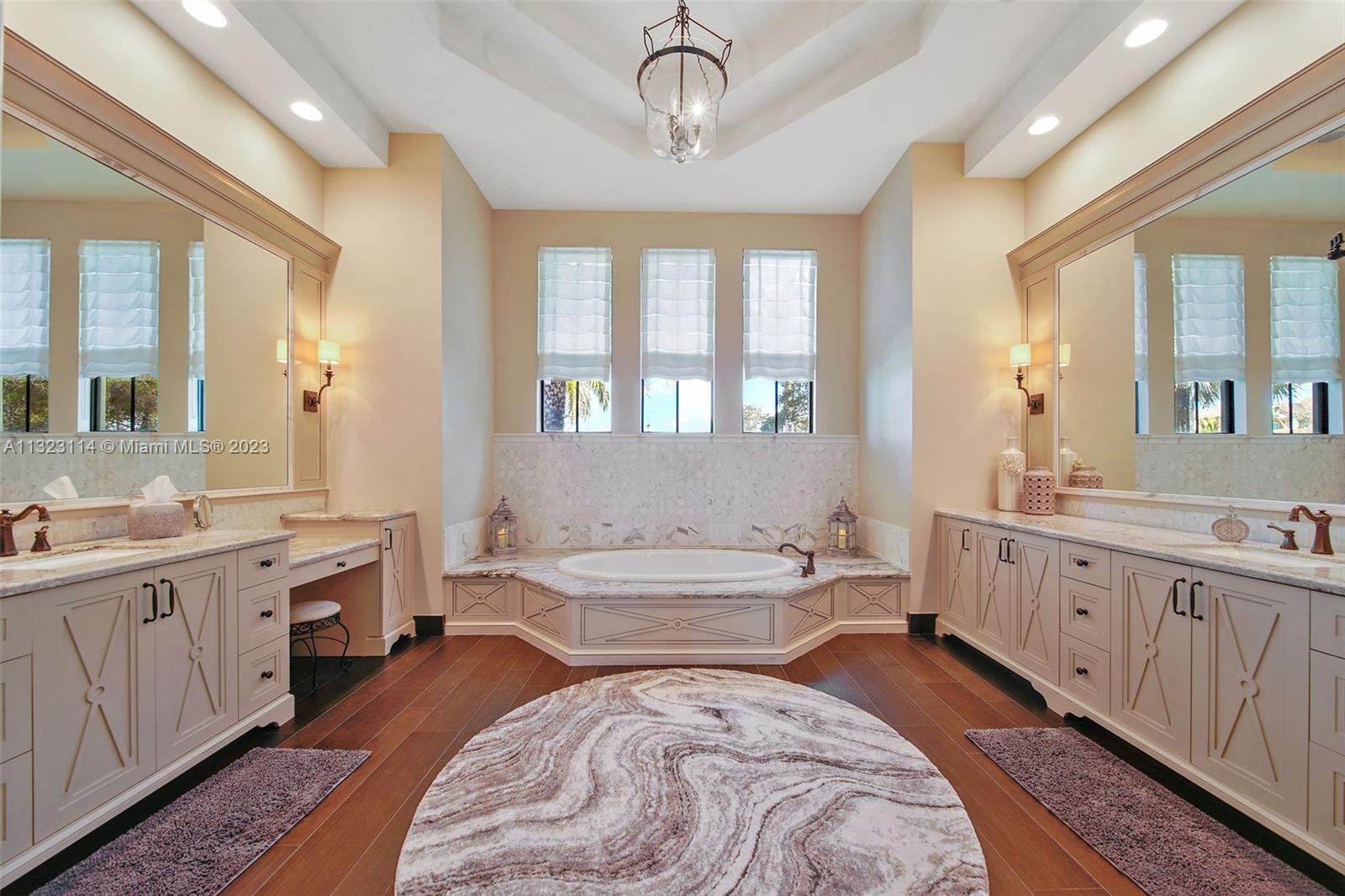 2863 Lake Ridge Lane Weston, FL 33332 - Photo 20 of 60 a spacious bathroom with a double vanity sink a large mirror and a bathtub