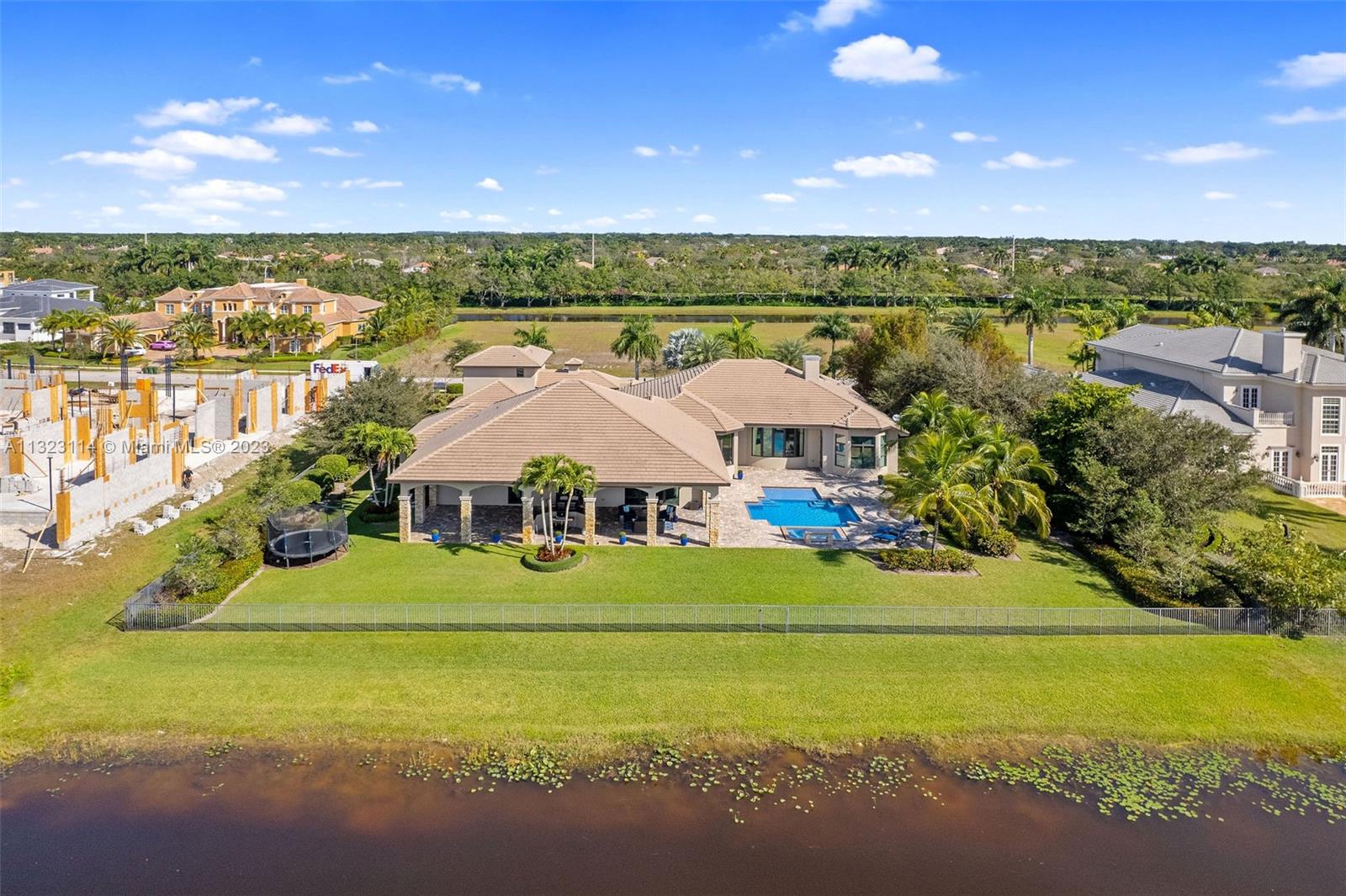 2863 Lake Ridge Lane Weston, FL 33332 - Photo 2 of 60 a front view of a house with a garden and outdoor space