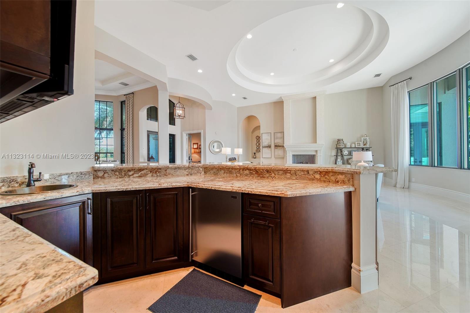 2863 Lake Ridge Lane Weston, FL 33332 - Photo 24 of 60 a kitchen with stainless steel appliances granite countertop a sink and a stove