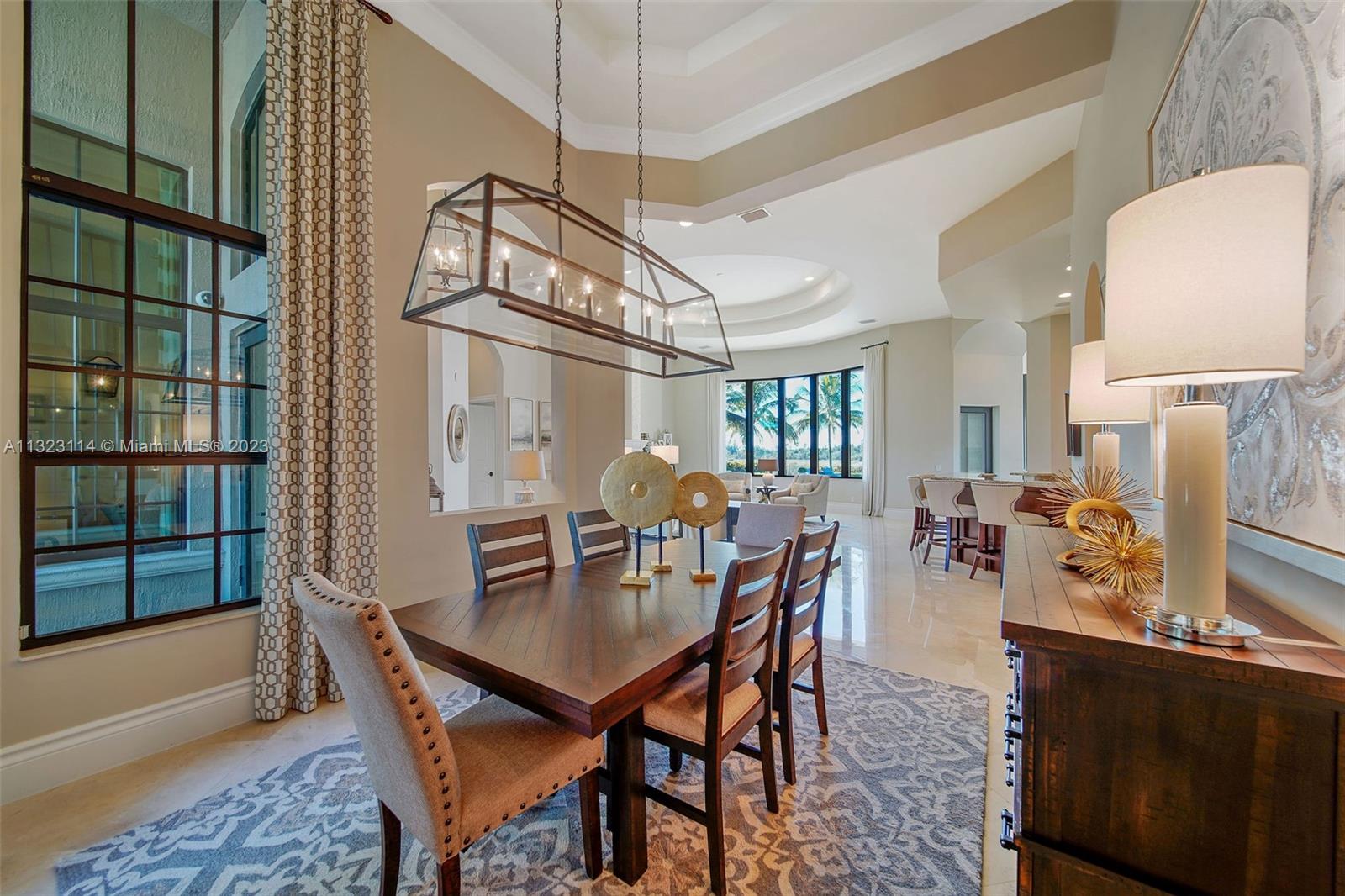 2863 Lake Ridge Lane Weston, FL 33332 - Photo 25 of 60 a view of a dining room with furniture and chandelier