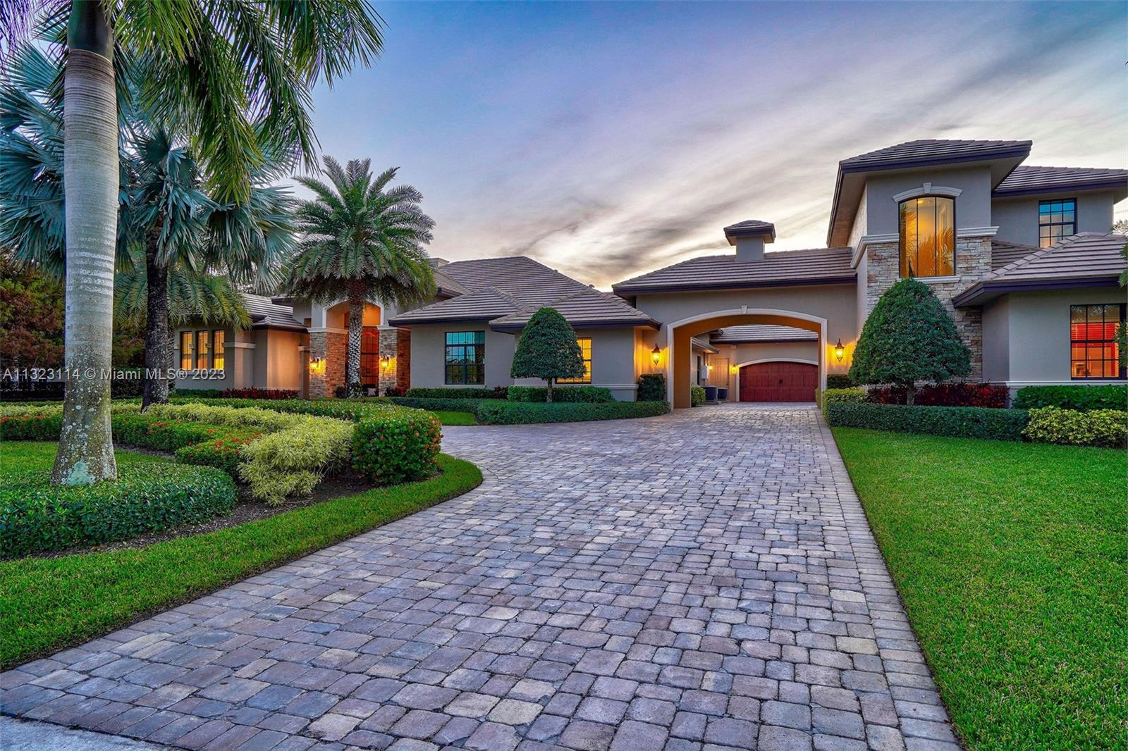 2863 Lake Ridge Lane Weston, FL 33332 - Photo 3 of 60 a front view of house with yard and green space